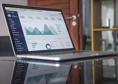 Laptop displaying SpineLegal Software analytics dashboard, highlighting legal practice management and data insights.