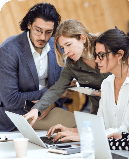 Team collaborating on SpineLegal Software, enhancing legal workflow efficiency on a laptop in a modern workspace.