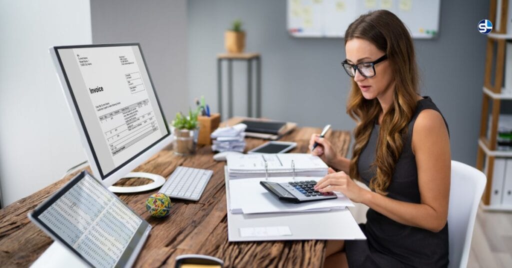 Professional using SpineLegal Software for efficient invoice management at a modern office desk.
