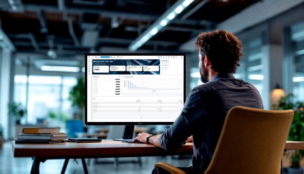 Man using SpineLegal Software on a computer in a modern office setting for legal data management.