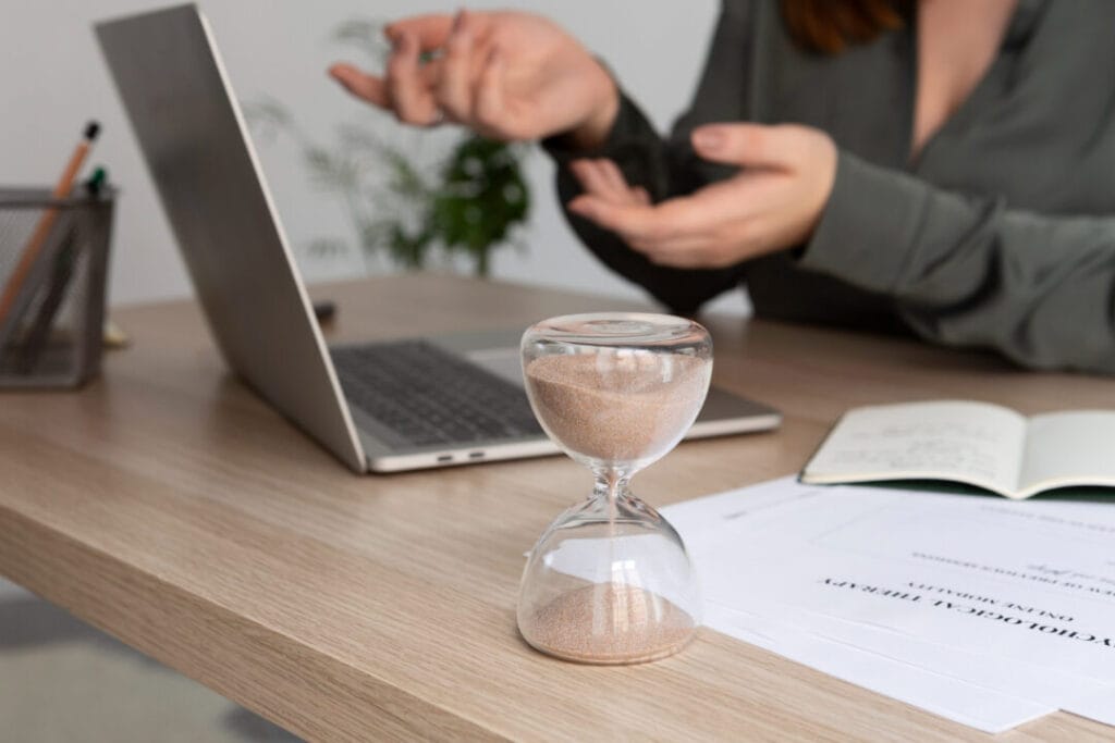 Hourglass on desk symbolizes efficient time management with SpineLegal Software.