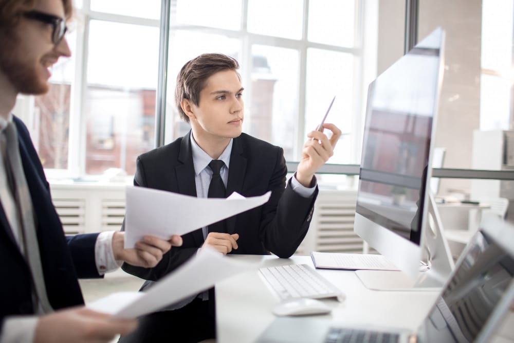 Teams collaborate on legal solutions using SpineLegal Software in a modern office setting.