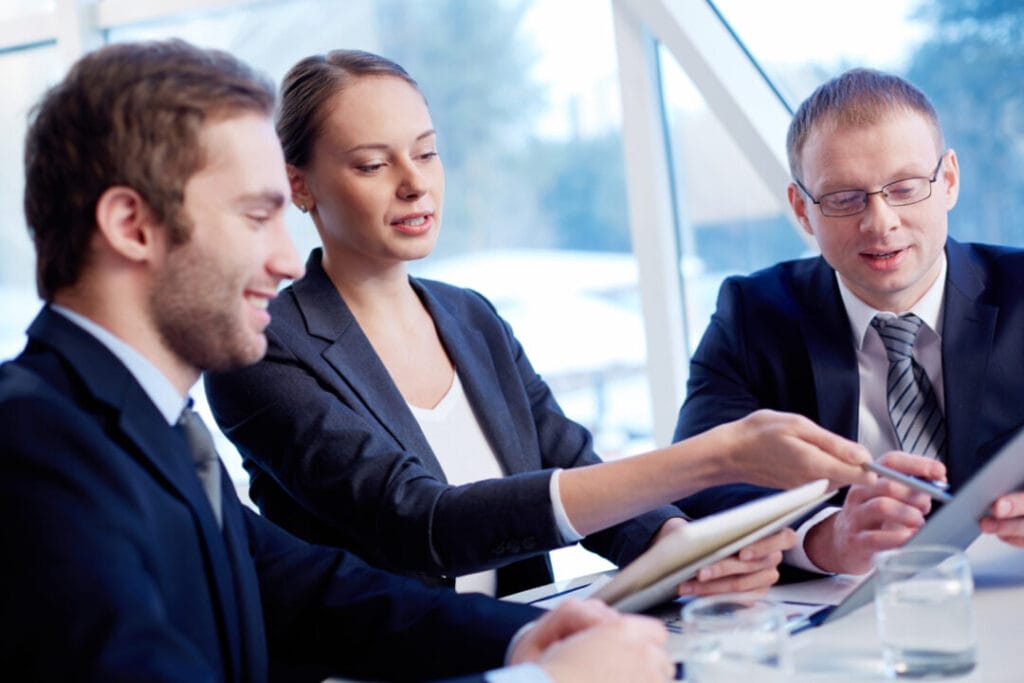 Team discussing legal strategies with SpineLegal software in a modern office setting.