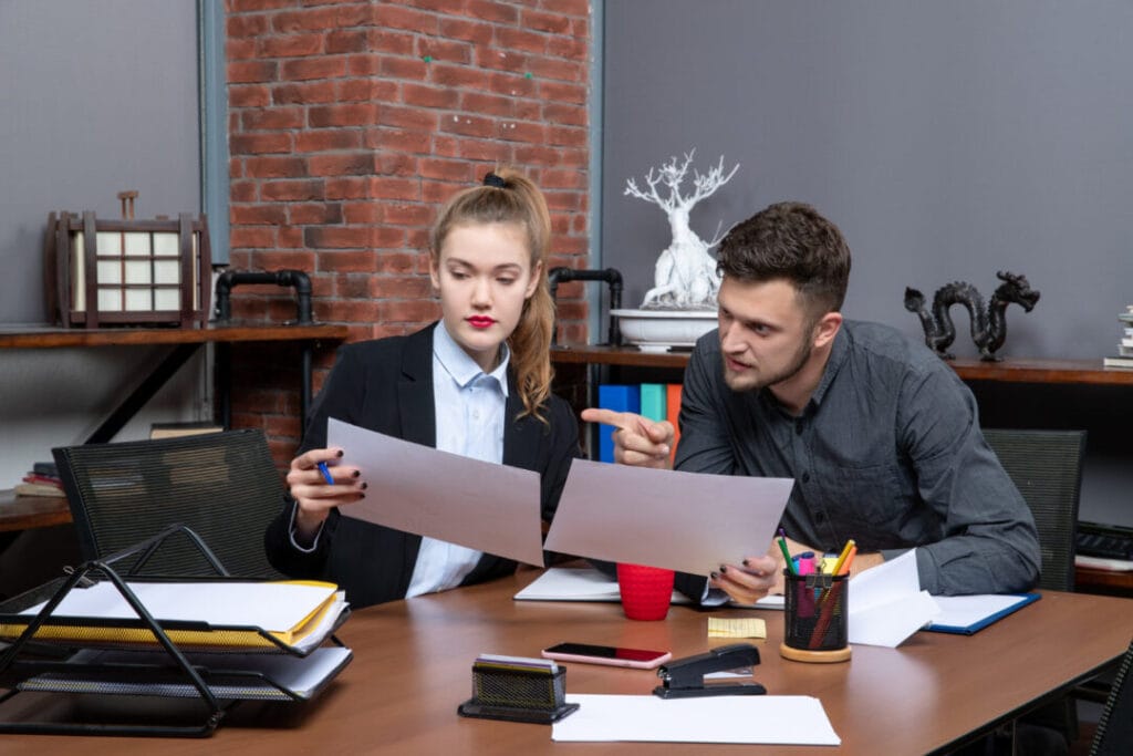 Team collaborating in office on legal documents using SpineLegal software for streamlined workflow.