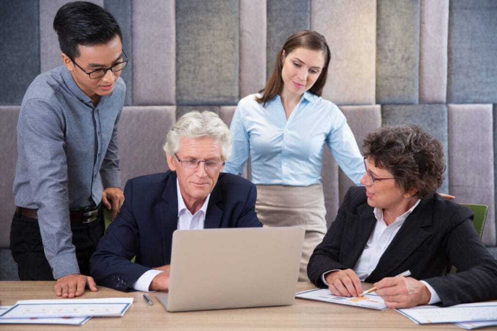 Legal team collaborating on SpineLegal Software, analyzing data on a laptop for optimized workflow solutions.